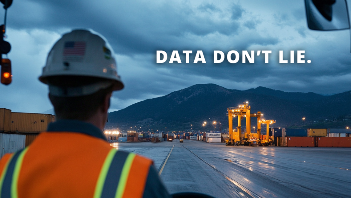 A shipping yard worker in a hard hat and safety vest looks out over a container yard at dusk, with dark storm clouds over a mountain range. Bright yellow cranes and stacked cargo containers are illuminated in the distance. Bold white text on the sky reads: “DATA DON’T LIE.”