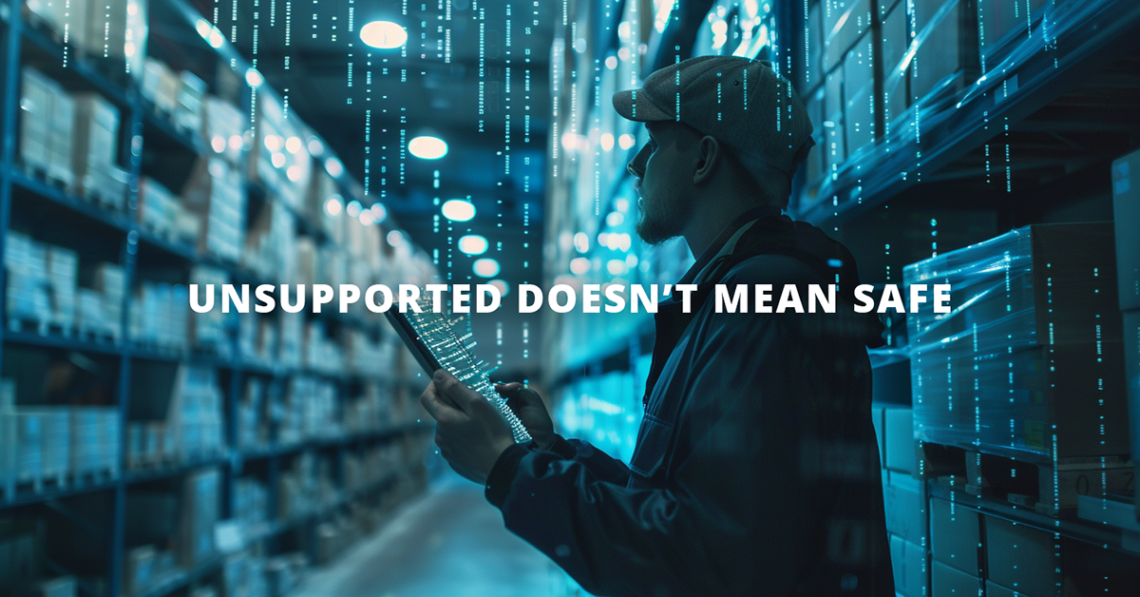 A man in a warehouse setting with spooky lighting, using an EOL device at risk for a cybersecurity breath.